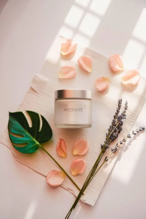Minimalist skincare product photo styled with lavender and petals on a beige background – aesthetic accessories product photography example.