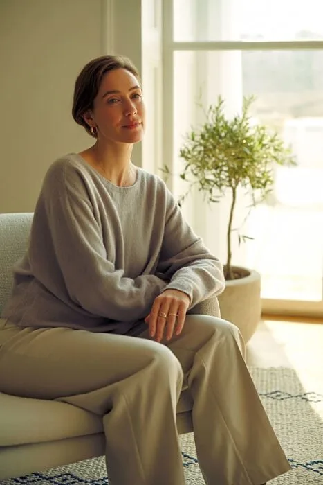 Woman seated indoors for a 40th birthday photoshoot.
