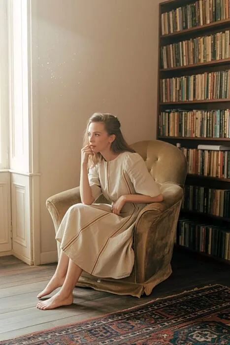 Woman wearing retro-style clothing posing indoors for a birthday photo.