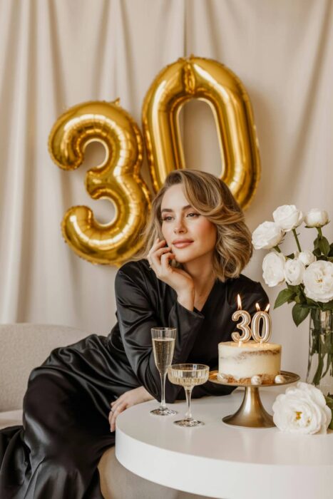elegant 30th birthday photoshoot with gold balloons cake and champagne