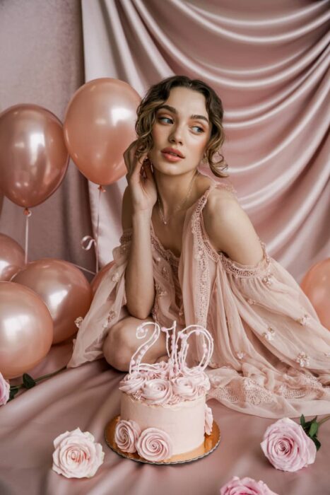 pink 21st birthday photoshoot with balloons cake and satin backdrop