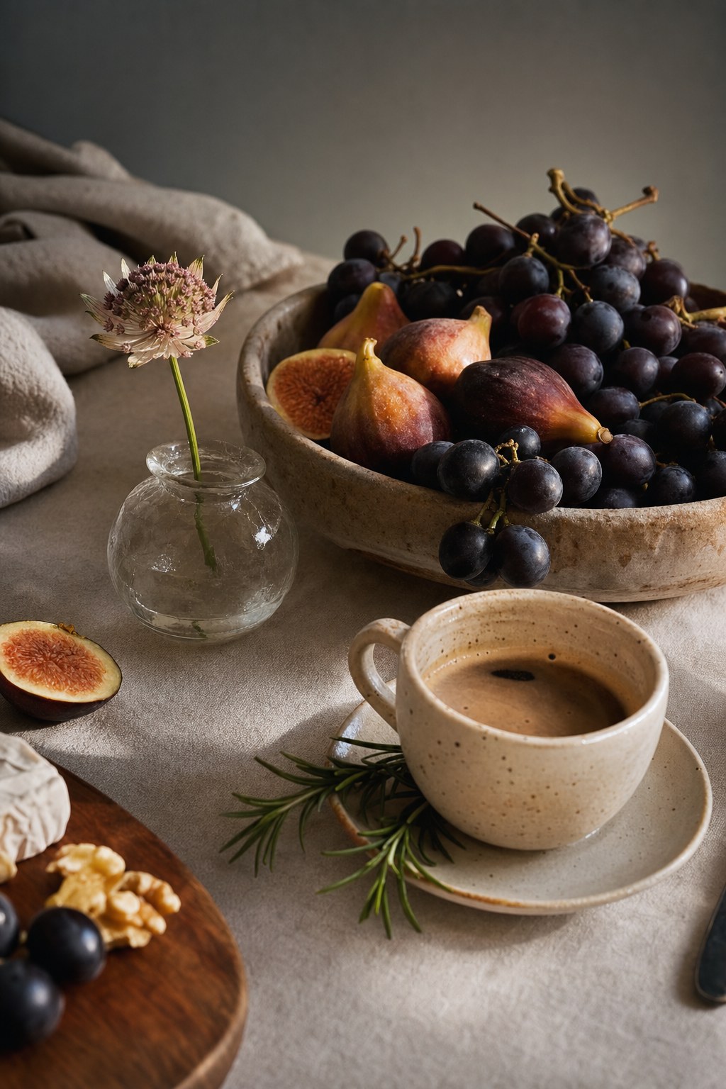 Still life photography objects arranged by category &mdash; fruit, flowers, food, and ceramics on linen